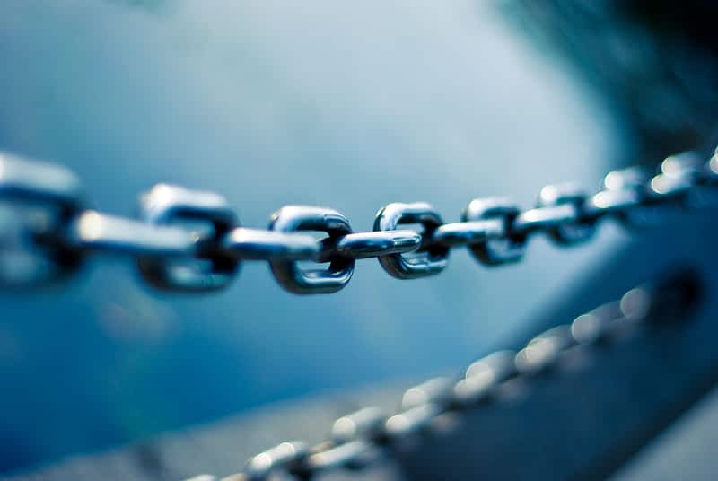 a metal chain in front of a blue background